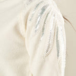 Maglia donna manica lunga con collo alto e applicazioni strass.  Eleganza brillante e comfort quotidiano. MA002800 AVORIO ARTIGLI 
